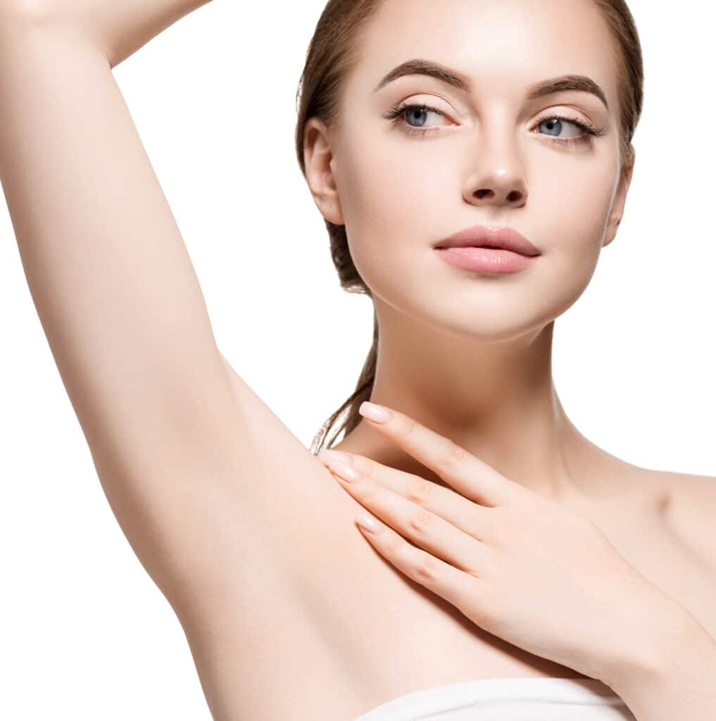 Confident girl displaying hairless underarms and delicately touching her neck, highlighting smooth, hair-free skin.